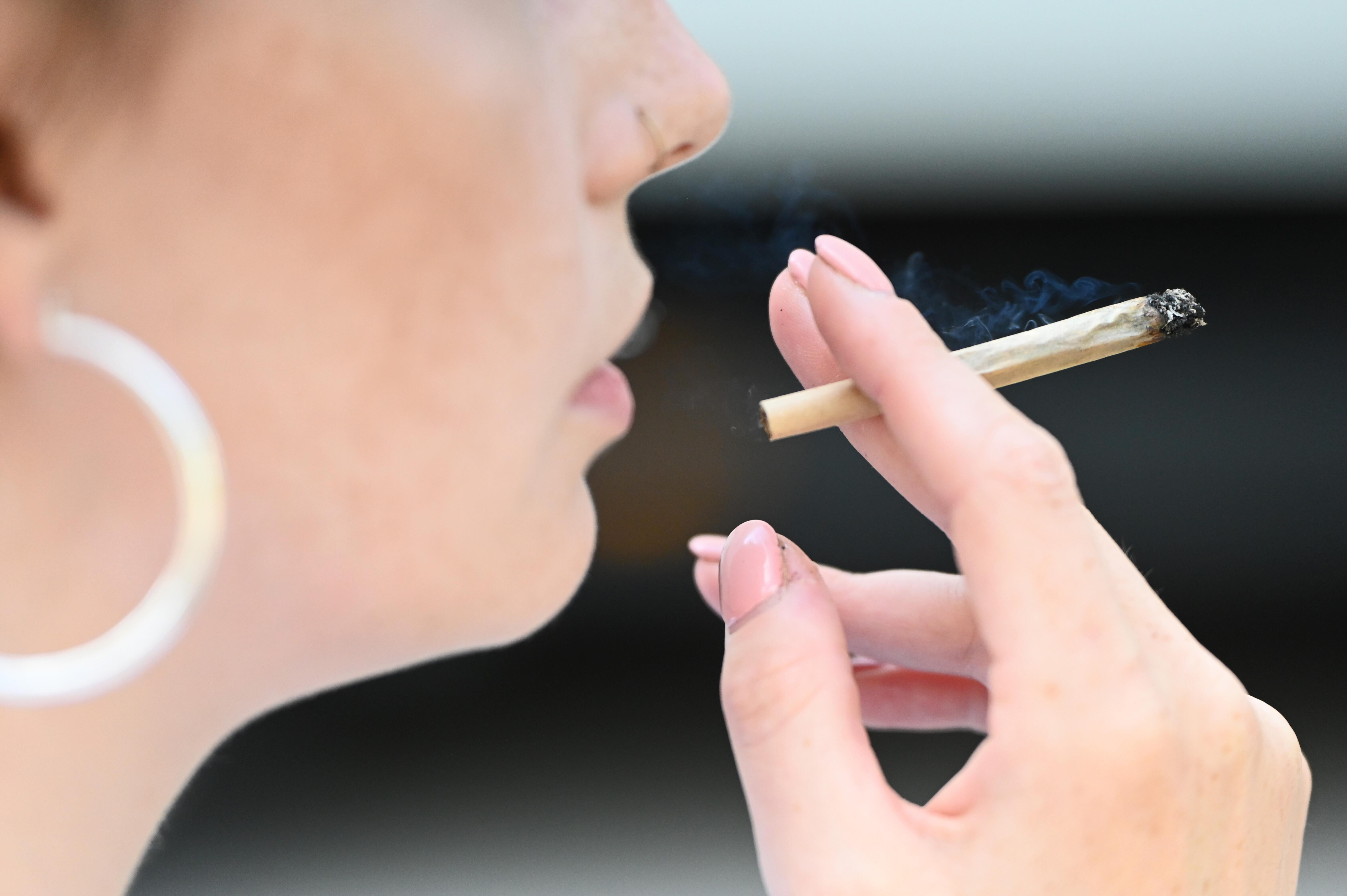 Eine Frau raucht einen Joint.
