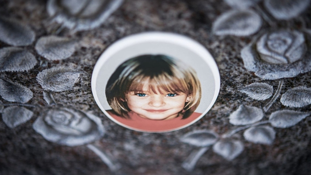 Ein Foto auf einem Grabstein zeigt ein Mädchen.
