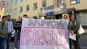 Menschen halten vor einem Gebäude in Würzburg ein Plakat mit der Aufschrift "Dawonia, es reicht!". | Bild:BR/Pirmin Breninek