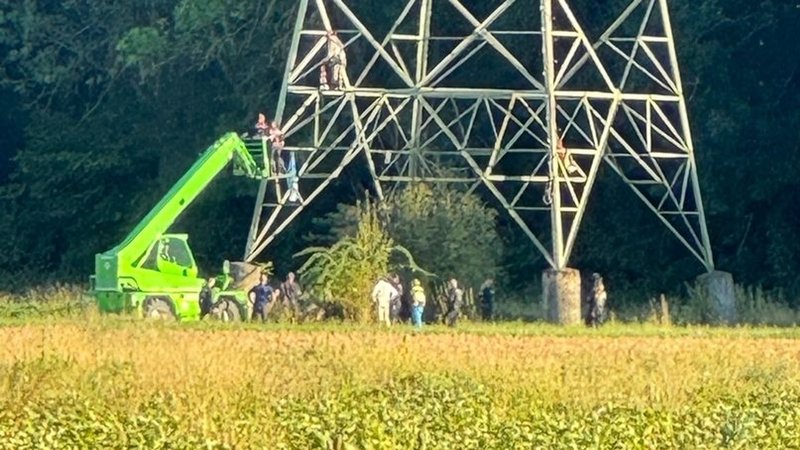 Der Aktivist kettete sich an einen Strommast, um die Sprengung des Atomkraftwerks zu verzögern. | Bild: Polizei Schweinfurt Der Aktivist kettete sich an einen Strommast, um die Sprengung des Atomkraftwerks zu verzögern.