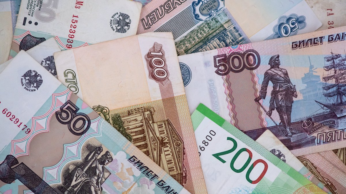 Russische Rubel-Banknoten liegen auf einem Tisch. 
