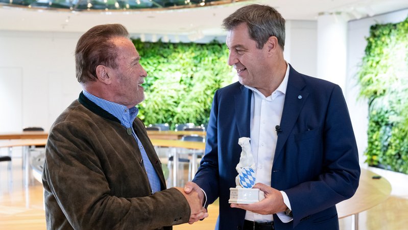Ministerpräsident Söder (r., CSU) verleiht Schwarzenegger, Schauspieler und ehemaliger Gouverneur von Kalifornien, den "Blauen Panther".