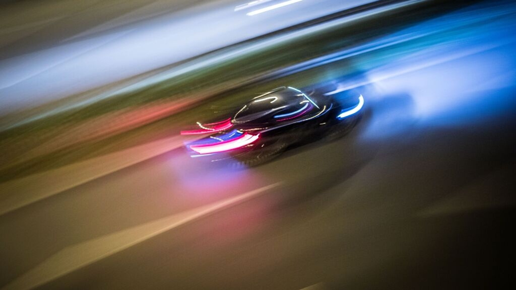 Ein Auto ist bei Dunkelheit auf einer Straße unterwegs (Symbolbild)