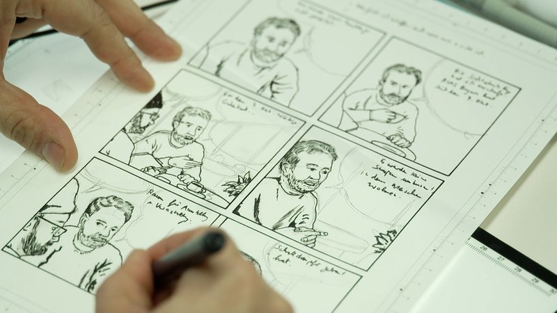 Eine Hand zeichnet eine Comicfigur.