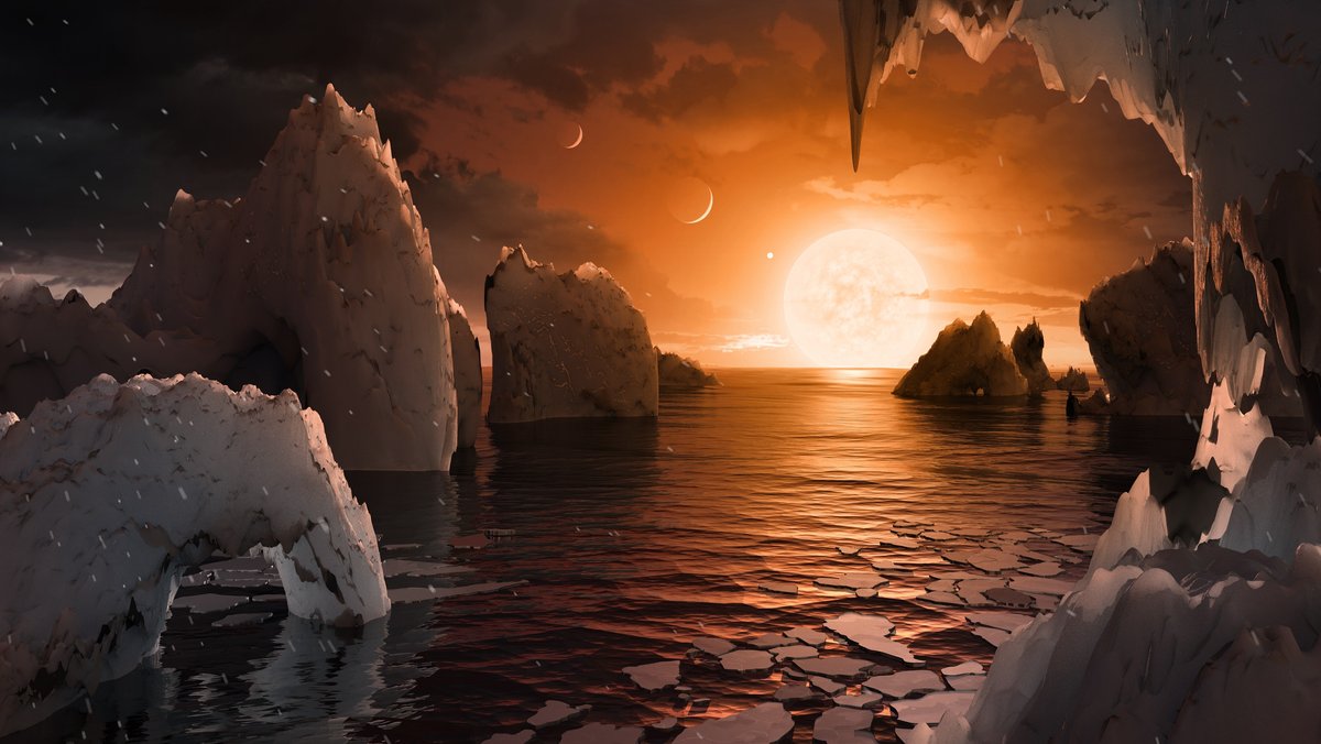 Gesteinsbrocken, Wasser und eine rote Sonne: Die grafische Darstellung zeigt, wie die Oberfläche des Exoplaneten Trappist-1f möglicherweise aussieht. 