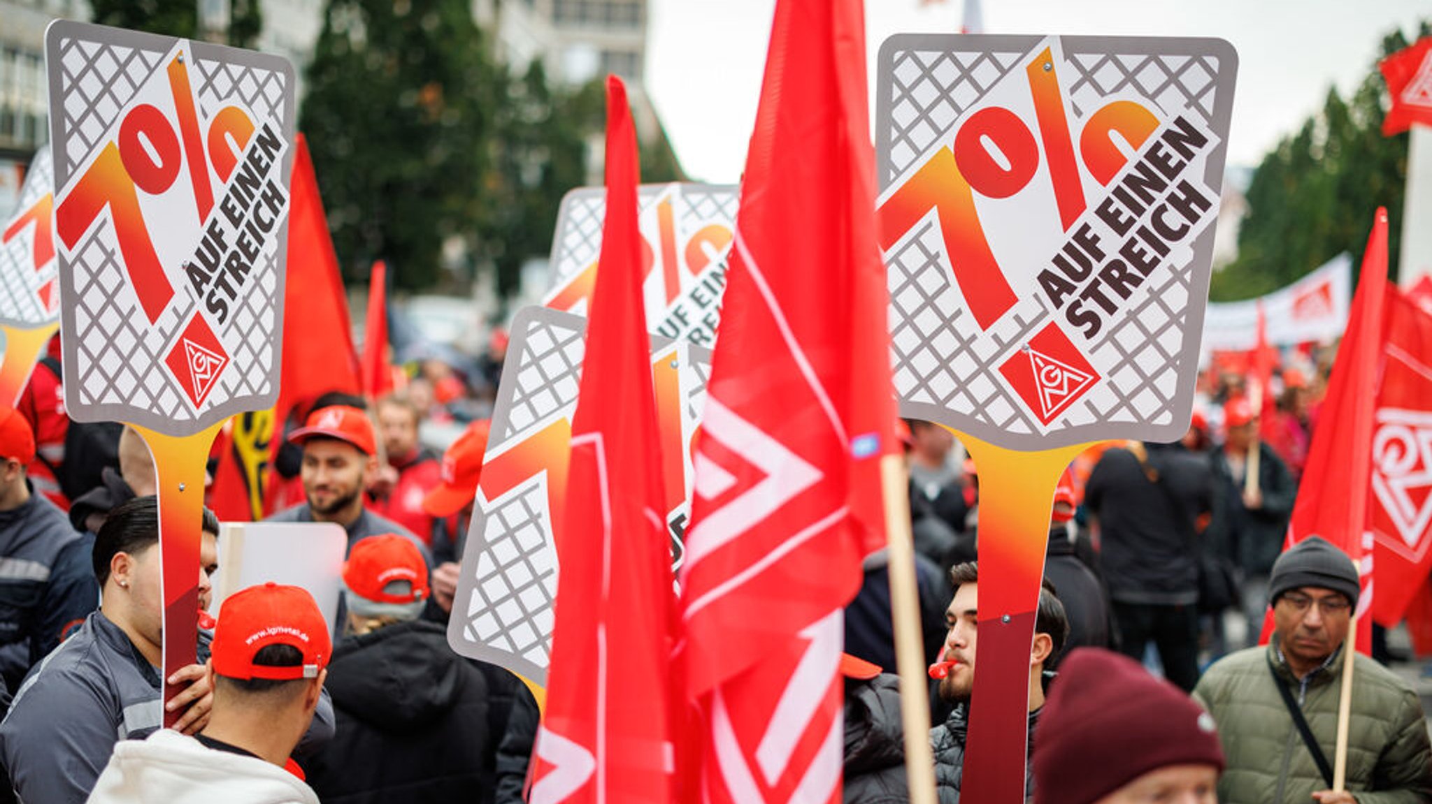 ARCHIV - 15.10.2024, Bayern, Nürnberg: Schilder mit der Aufschrift «7 Prozent auf einen Streich» sind während einer Kundgebung in der bayerischen Metall- und Elektro-Industrie zu sehen. (zu dpa: «IG Metall Bayern weitet Warnstreiks aus») Foto: Daniel Karmann/dpa +++ dpa-Bildfunk +++