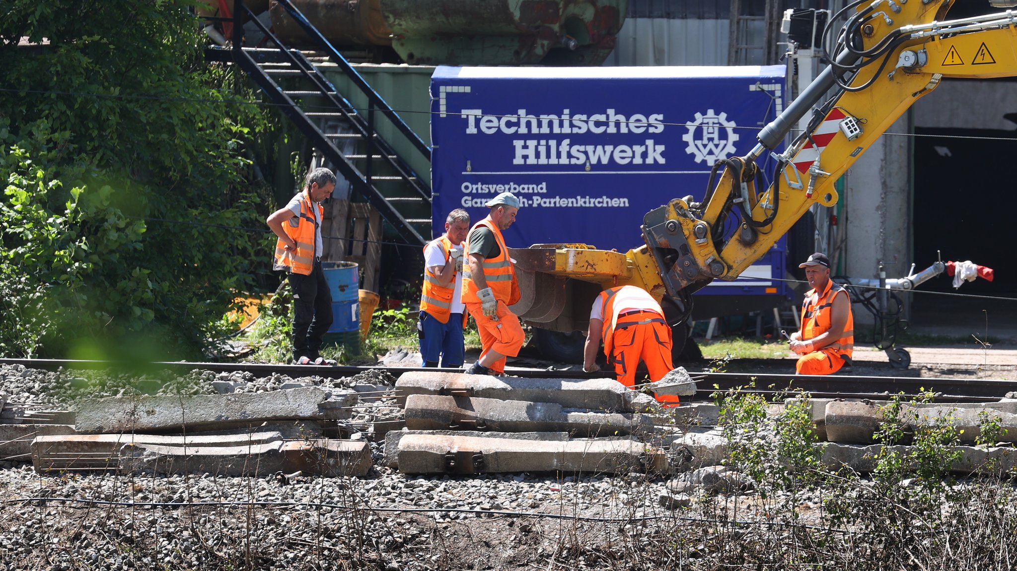 Bahnmitarbeiter arbeiten am Gleisbett unweit der Unfallstelle bei Garmisch-Partenkirchen. 