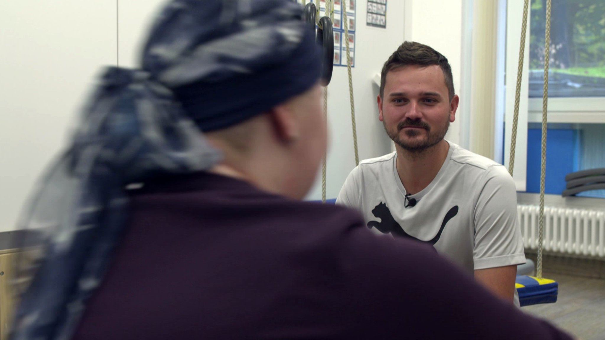 Ein Sporttherapeut im Training mit einem Kind. | Bild: BR Ein Sporttherapeut im Training mit einem Kind.