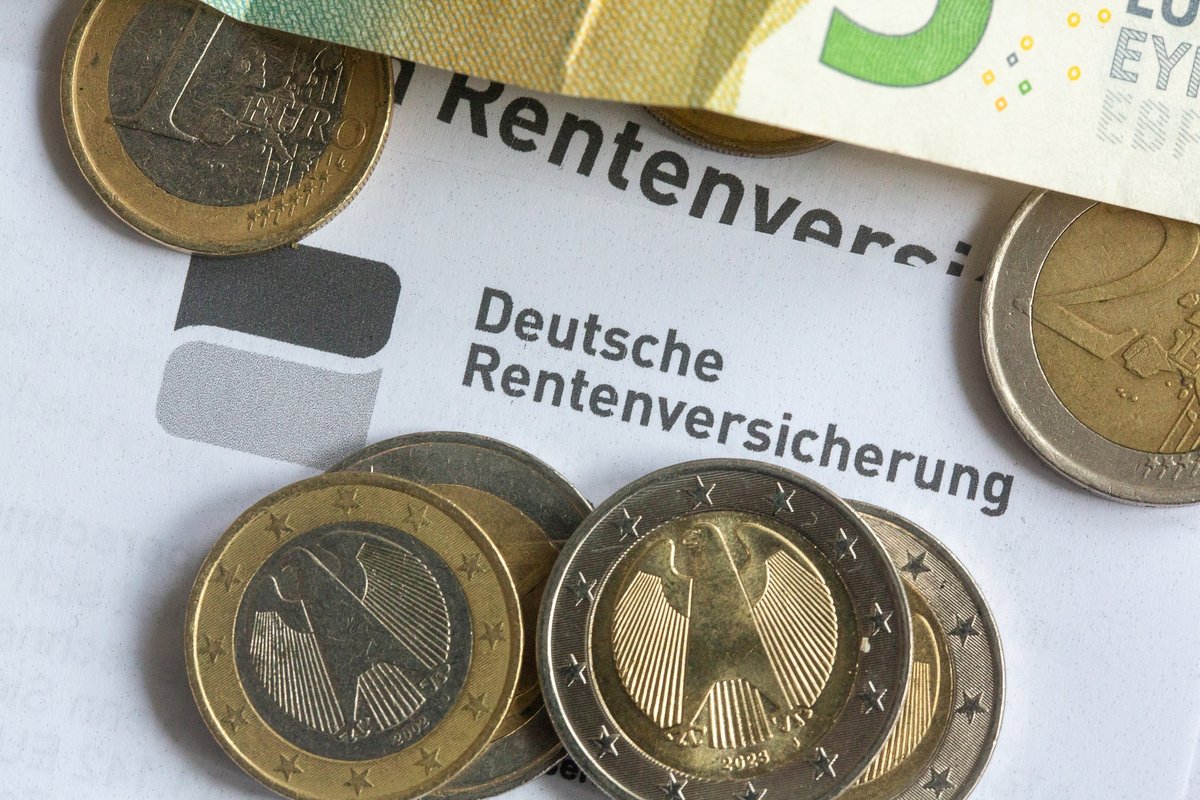 Geld liegt auf einem Schreiben der Deutschen Rentenversicherung.