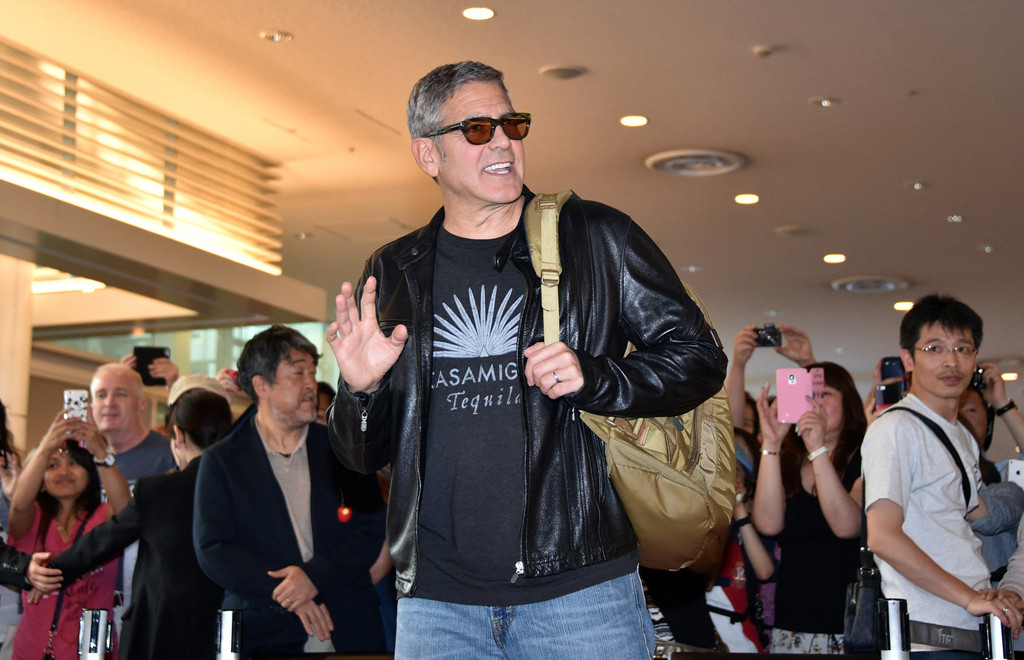George Clooney vor fotografierenden Menschen.