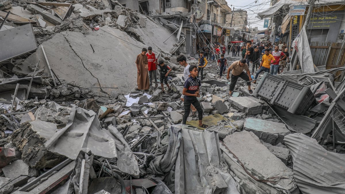 Menschen auf Trümmerhaufen in Chan Yunis, Gazastreifen