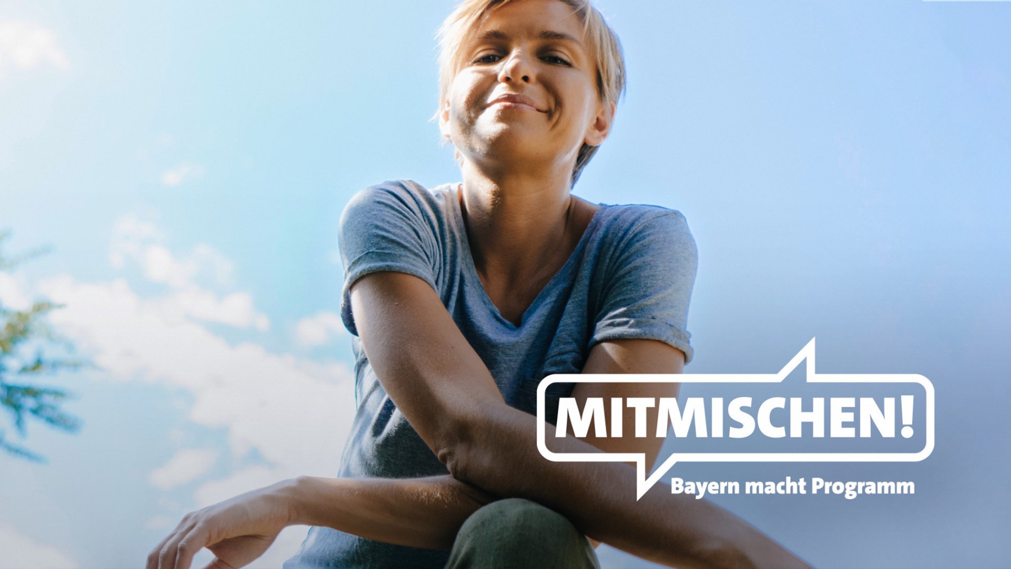 Eine junge Frau vor dem Motto "Mitmischen! Bayern macht Programm"