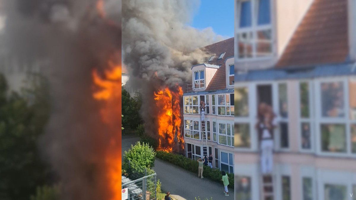 Mit einer Leiter rettet ein Hausmeister zwei Menschen aus einem brennenden Haus.