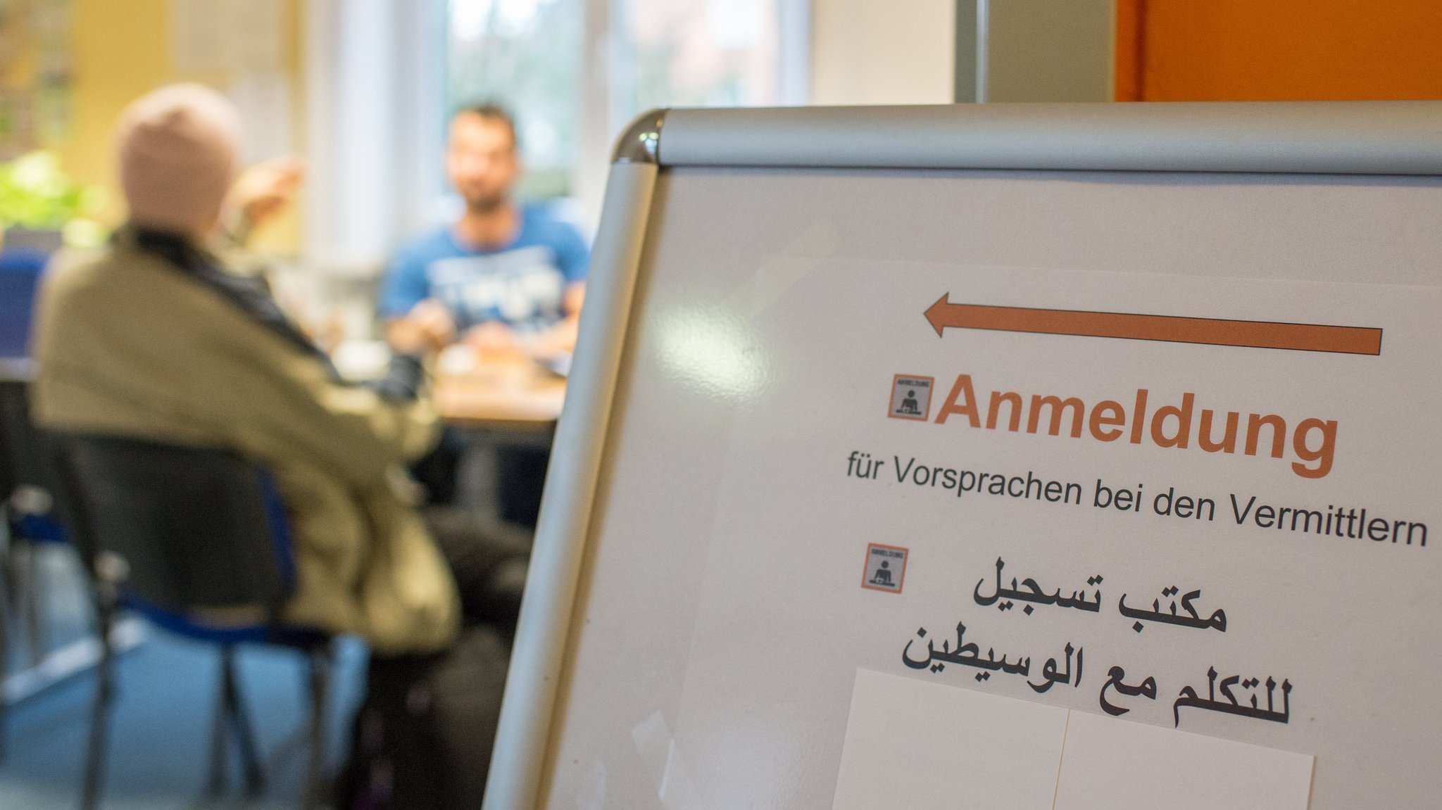 (Symbolbild) Schild in einem bayerischen Jobcenter auf arabischer Sprache.