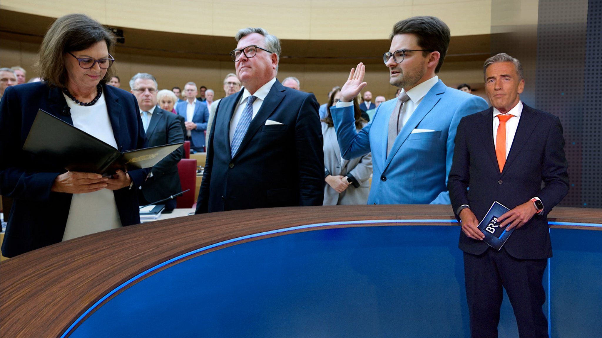 BR24-Moderator Stefan Scheider mit einem Foto der beiden Minister nebst Landtagspräsidentin Ilse Aigner. | Bild: BR BR24-Moderator Stefan Scheider mit einem Foto der beiden Minister nebst Landtagspräsidentin Ilse Aigner.
