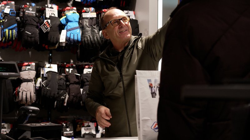 Ein Mann vor Handschuhen, die zum Verkauf an der Wand hängen. | Bild: BR Ein Mann vor Handschuhen, die zum Verkauf an der Wand hängen.