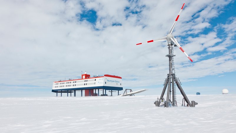 Die Polar-Forschungsstation Neumayer III. in der Antarktis, daneben steht ein Windrad.