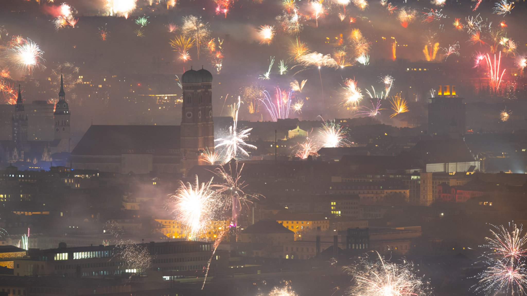 01.01.2024, München - Feuerwerk über der Landeshauptstadt, rund um die Frauenkirche explodieren Raketen und andere Feuerwerkskörper.