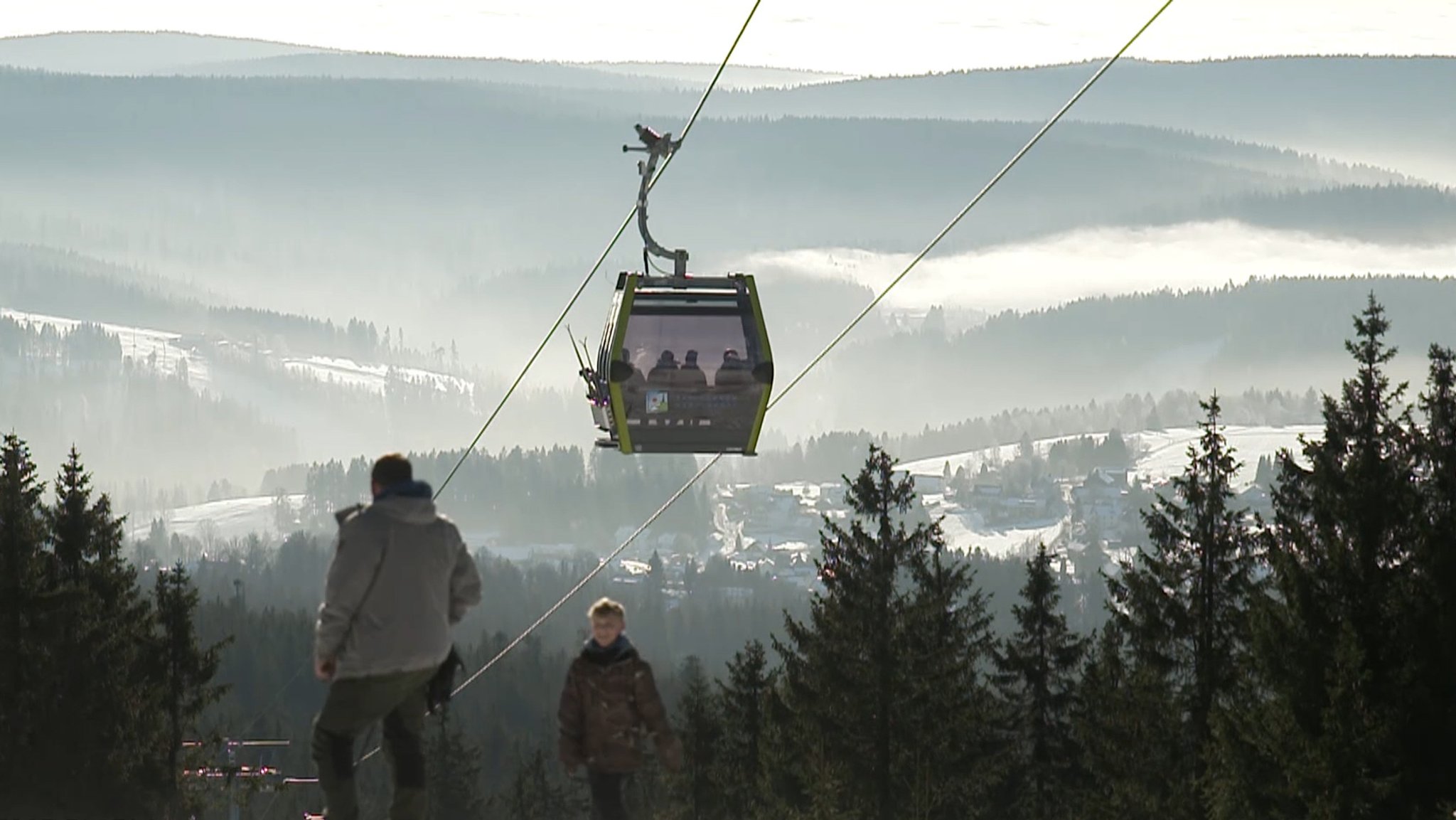 Eine Gondel, die Wintersportler auf den Gipfel transportiert.