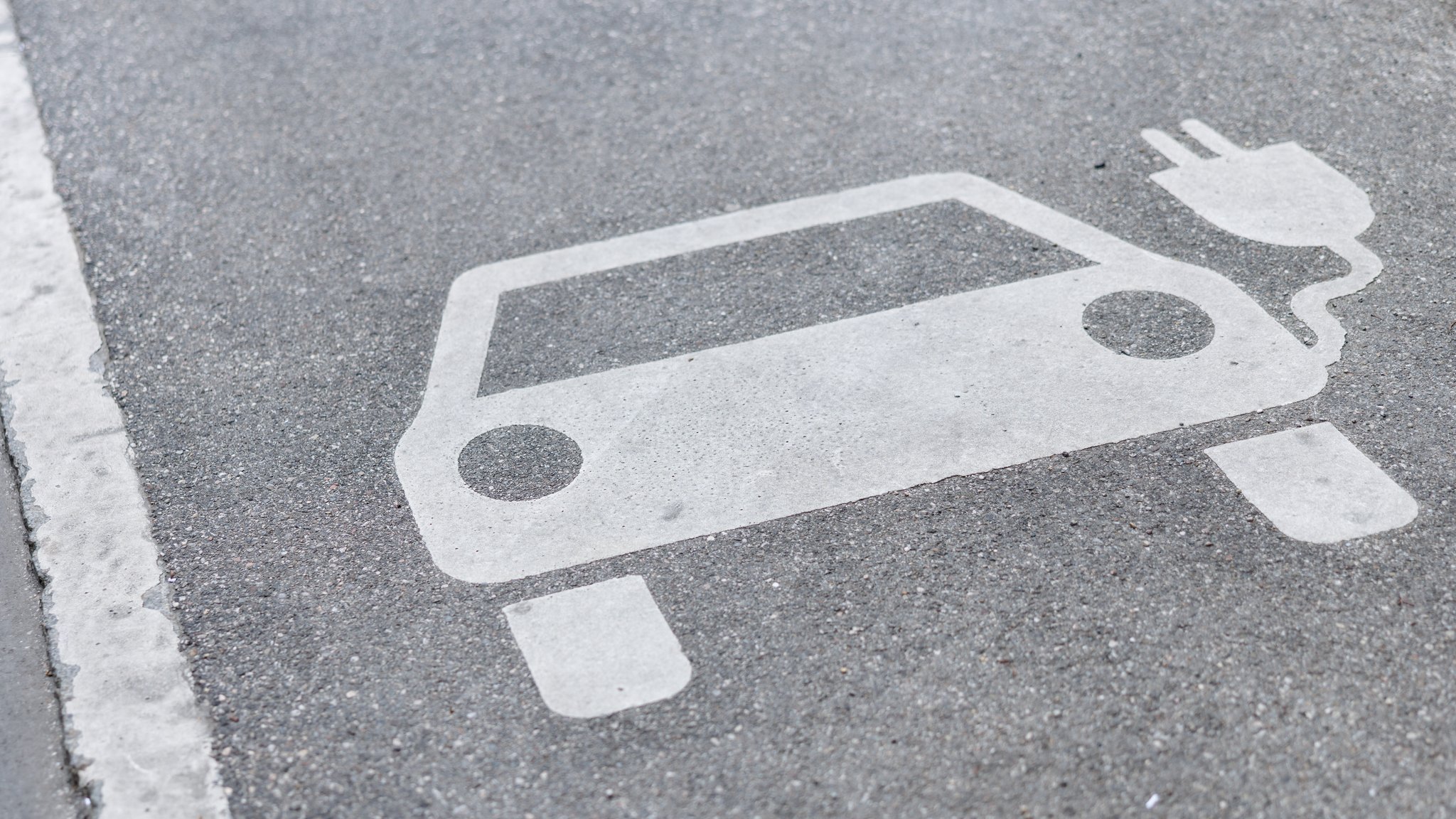 Eine Markierung auf der Straße weist am 21.05.2025 in München (Bayern) auf einen Parkplatz für Elektroautos hin, der während des Ladevorgangs besetzt werden darf.