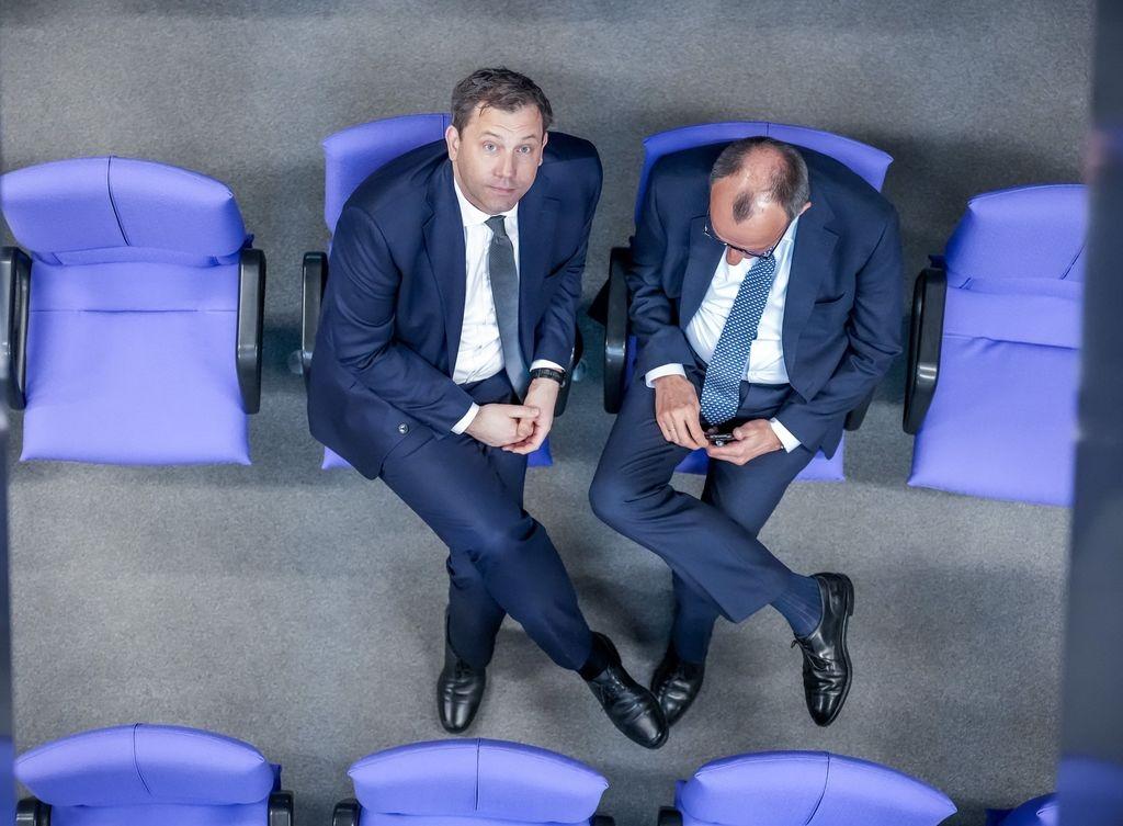 ARCHIV - 13.03.2025, Berlin: Lars Klingbeil (l), SPD Fraktionschef und Bundesvorsitzender, spricht mit Friedrich Merz, CDU/CSU Fraktionsvorsitzender und CDU Bundesvorsitzender, in den hinteren Sitzreihen der Union während der 213. Plenarsitzung der 20. Legislaturperiode im Deutschen Bundestag. In dieser und einer noch folgenden Sondersitzung des alten Bundestages sollen nach dem Willen von Union und SPD ein milliardenschweres Sondervermögen und eine Reform der im Grundgesetz verankerten Schuldenbremse beschlossen werden. Ziel sind Investitionen in Infrastruktur und Verteidigung. (zu dpa: «Klingbeil: Vertrauen zu Merz wächst») Foto: Michael Kappeler/dpa +++ dpa-Bildfunk +++