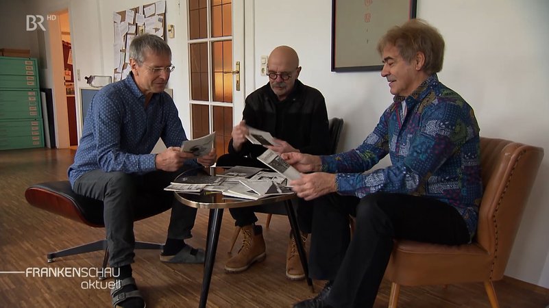 Die drei Herausgeber zusammen an einem Tisch. | Bild: BR Die drei Herausgeber zusammen an einem Tisch.