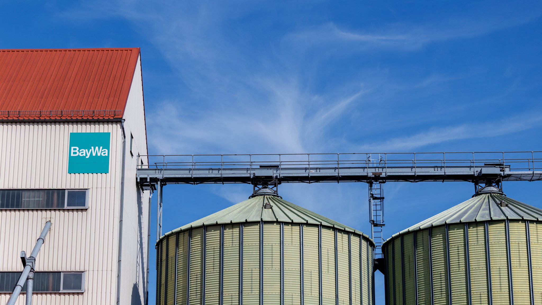 (Symbolbild) Das Logo und der Schriftzug vom international tätigen Konzern BayWa AG ist am 27.07.2025 an der Fassade von einem Gebäude mit zwei angrenzenden Silos am BayWa AG Agrar Vertriebsstandort in Rehau (Bayern) zu sehen.