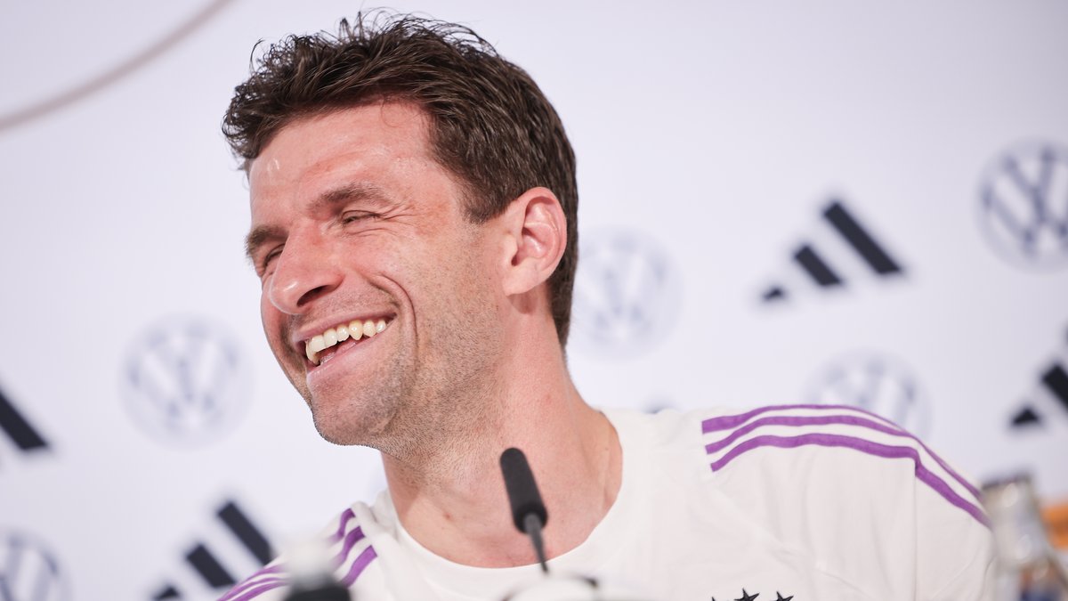 Thomas Müller lacht bei der Pressekonferenz