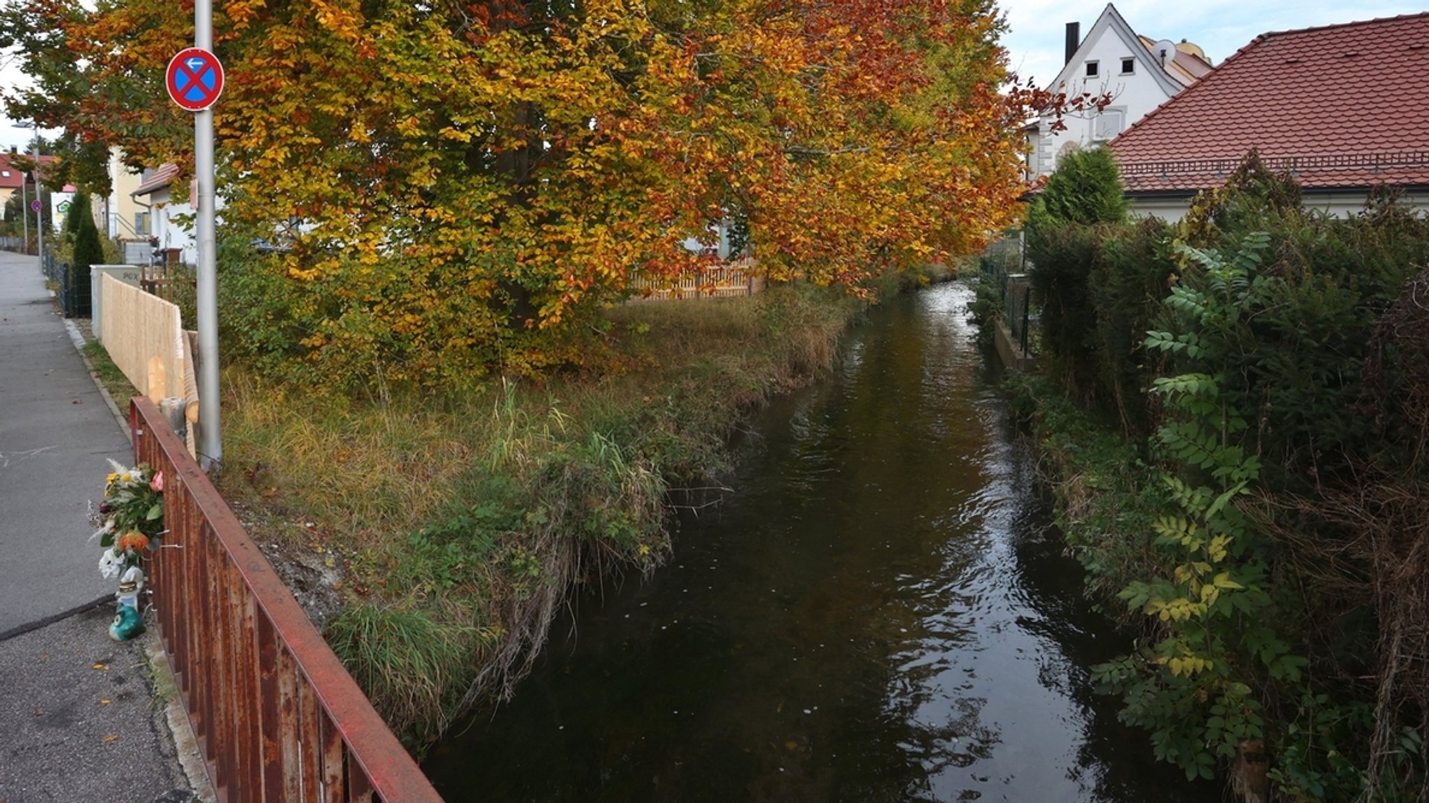 Der Mindelkanal: An einem Brückengeländer hängen Blumen