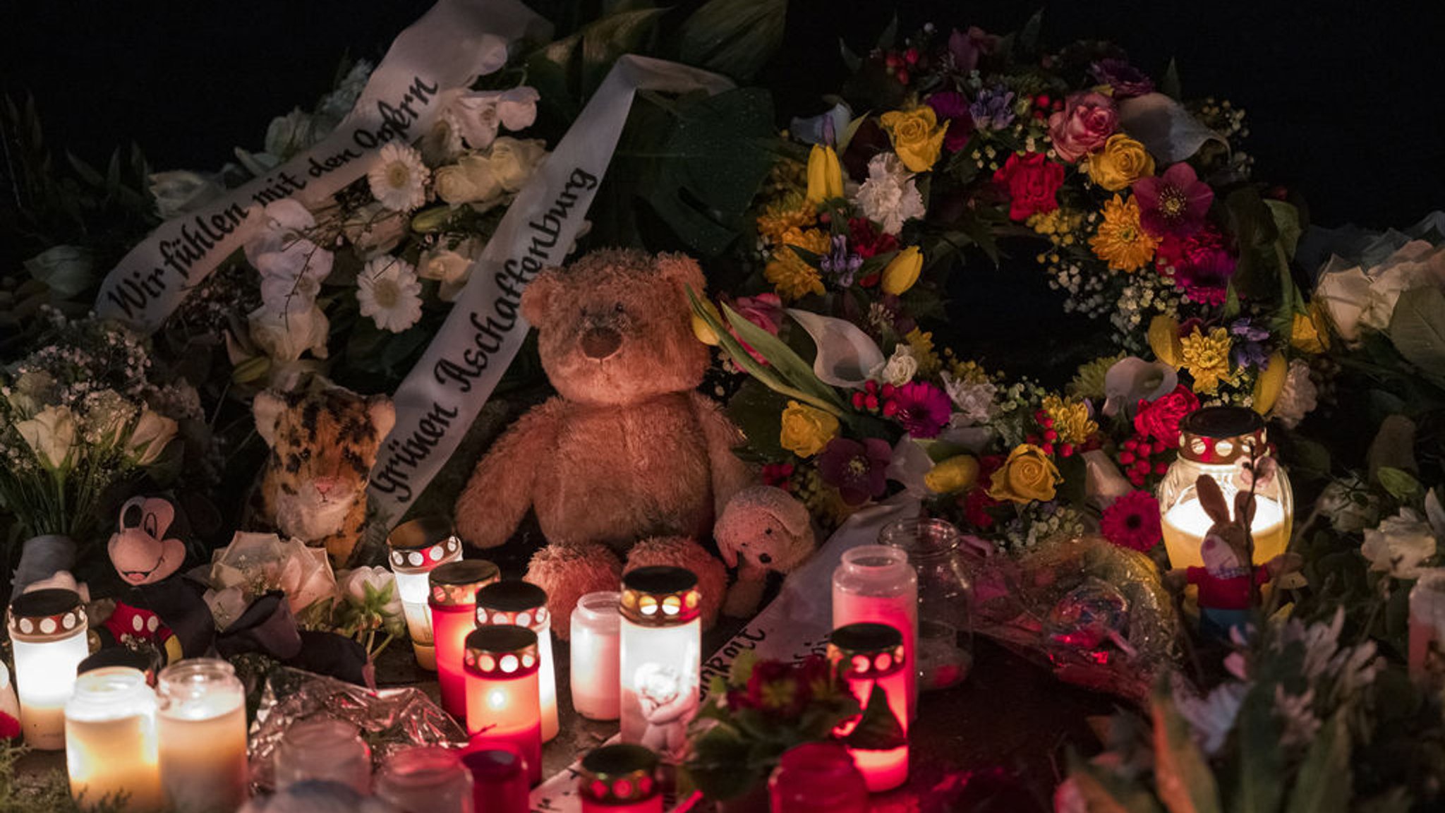 ARCHIV - 24.01.2025, Bayern, Aschaffenburg: Ein Teddybär liegt neben Blumenkränzen und Kerzen auf dem Boden und erinnert an den tödlichen Messerangriff. Zahlreiche Kerzen und Kuscheltiere erinnern am Freitagmorgen im Park Schöntal an die Opfer der tödlichen Messerattacke. (zu dpa: «Fast eine halbe Million für Betroffene der Messerattacke») Foto: Daniel Vogl/dpa +++ dpa-Bildfunk +++ | Bild: dpa-Bildfunk/Daniel Vogl ARCHIV - 24.01.2025, Bayern, Aschaffenburg: Ein Teddybär liegt neben Blumenkränzen und Kerzen auf dem Boden und erinnert an den tödlichen Messerangriff. Zahlreiche Kerzen und Kuscheltiere erinnern am Freitagmorgen im Park Schöntal an die Opfer der tödlichen Messerattacke. (zu dpa: «Fast eine halbe Million für Betroffene der Messerattacke») Foto: Daniel Vogl/dpa +++ dpa-Bildfunk +++