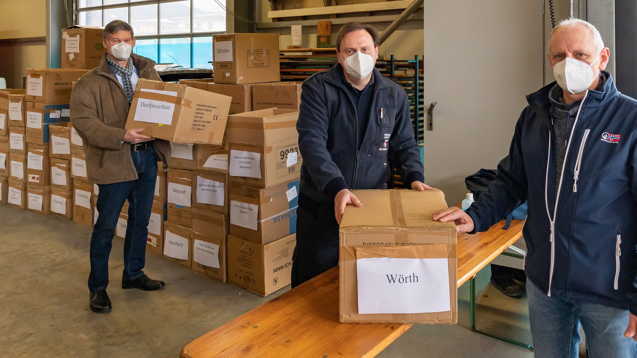 Zu den ersten Lehrkräften, die ihr Paket mit chirurgischen Masken für das Schulpersonal abholten, gehörte der Rektor der Wörther Grund- und Mittelschule, Thomas Krenz (rechts). Schulrat Harald Frankenberger (links) und Wolfgang Schmitt (Kreisbrandinspektion) lieferten die Masken aus.