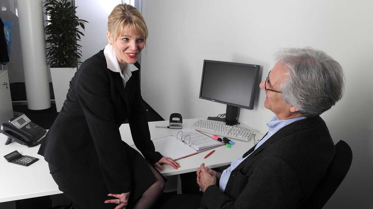 Von Models gespielte Szene: Eine Frau flirtet im Büro mit ihrem Chef (Symbolbild).