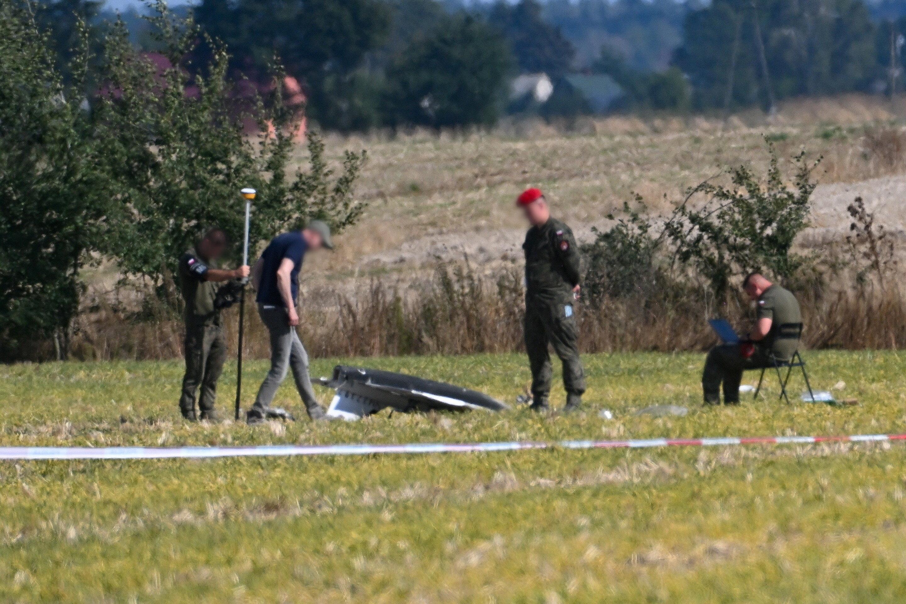 10.09.2025, Polen, Wohyn: Polizei und Militärpolizei sichern Teile einer beschädigten Drohne, die von polnischen Behörden abgeschossen wurde, auf einem Gelände in Wohyn.