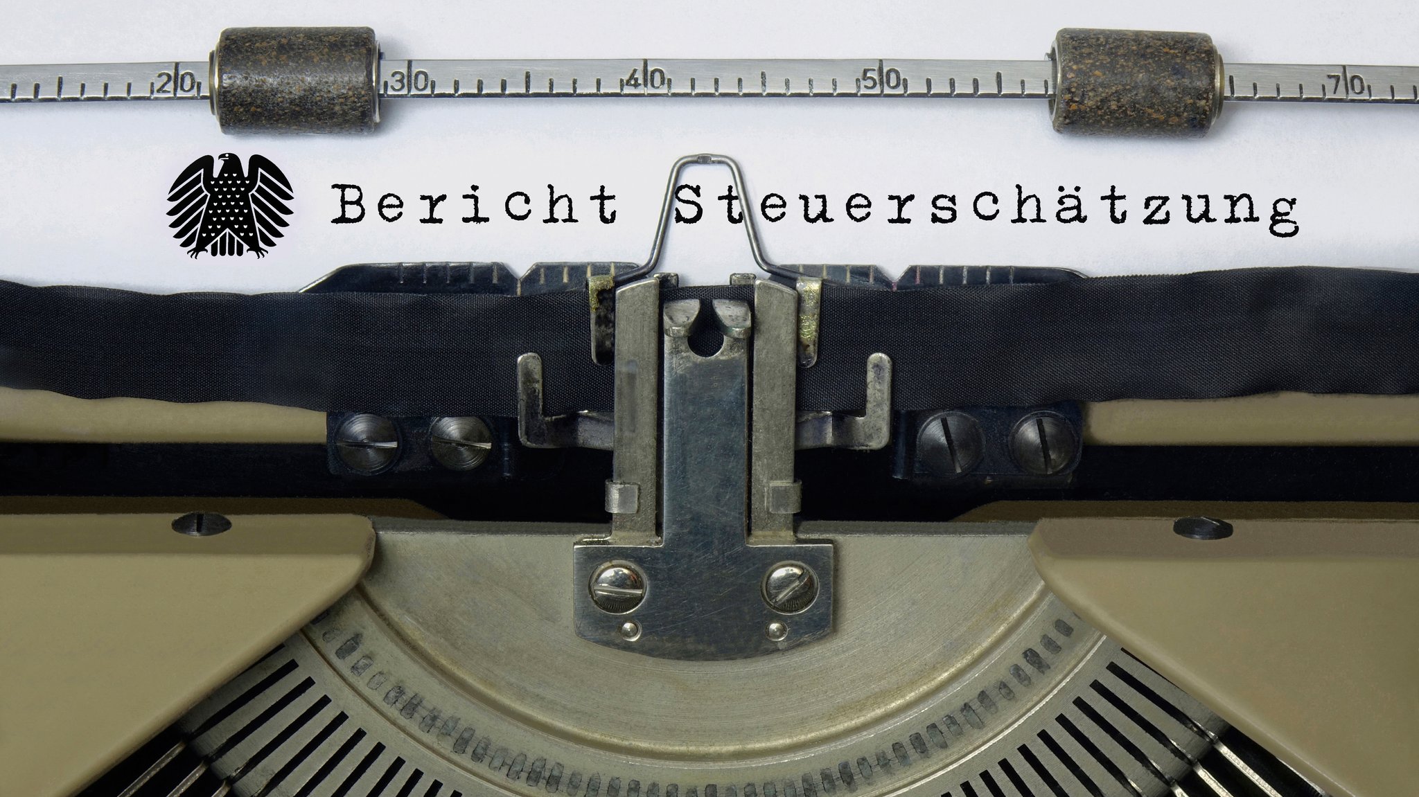 Auf dem Papier in einer Schreibmaschine steht der Schriftzug "Bericht Steuerschätzung" mit einem Bundesadler (Symbolbild).