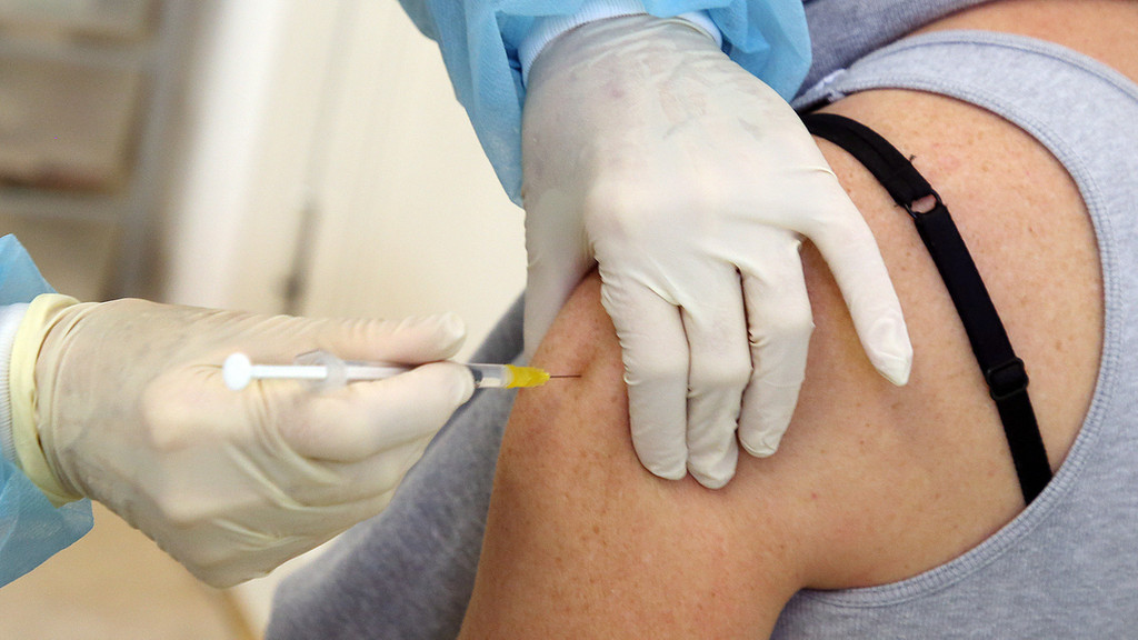 Eine Frau erhält eine Covid-Impfung.