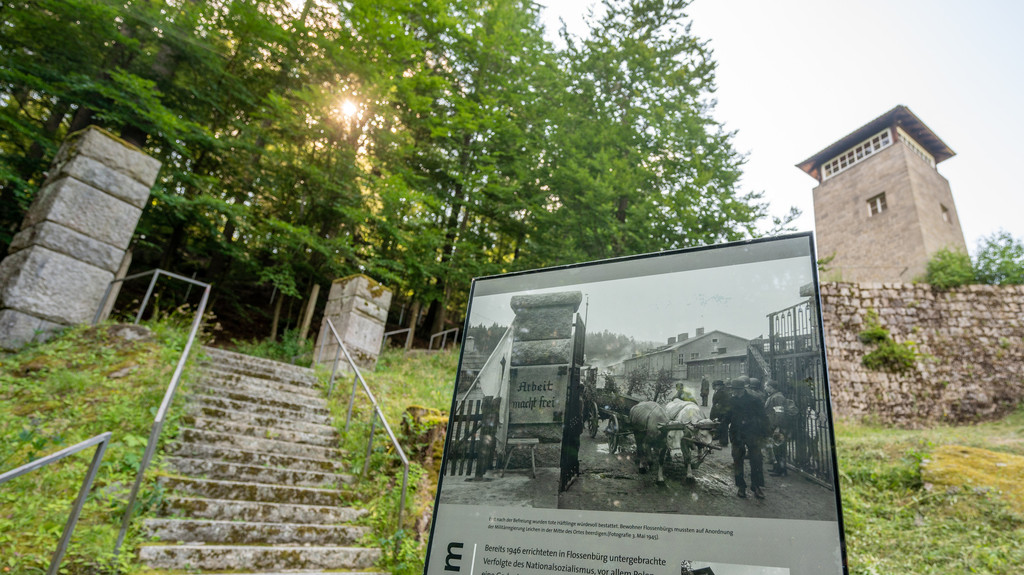 Eine Informationstafel vor einem ehemaligen Wachturm erinnert an das Martyrium für die Gefangenen in Flossenbürg.
