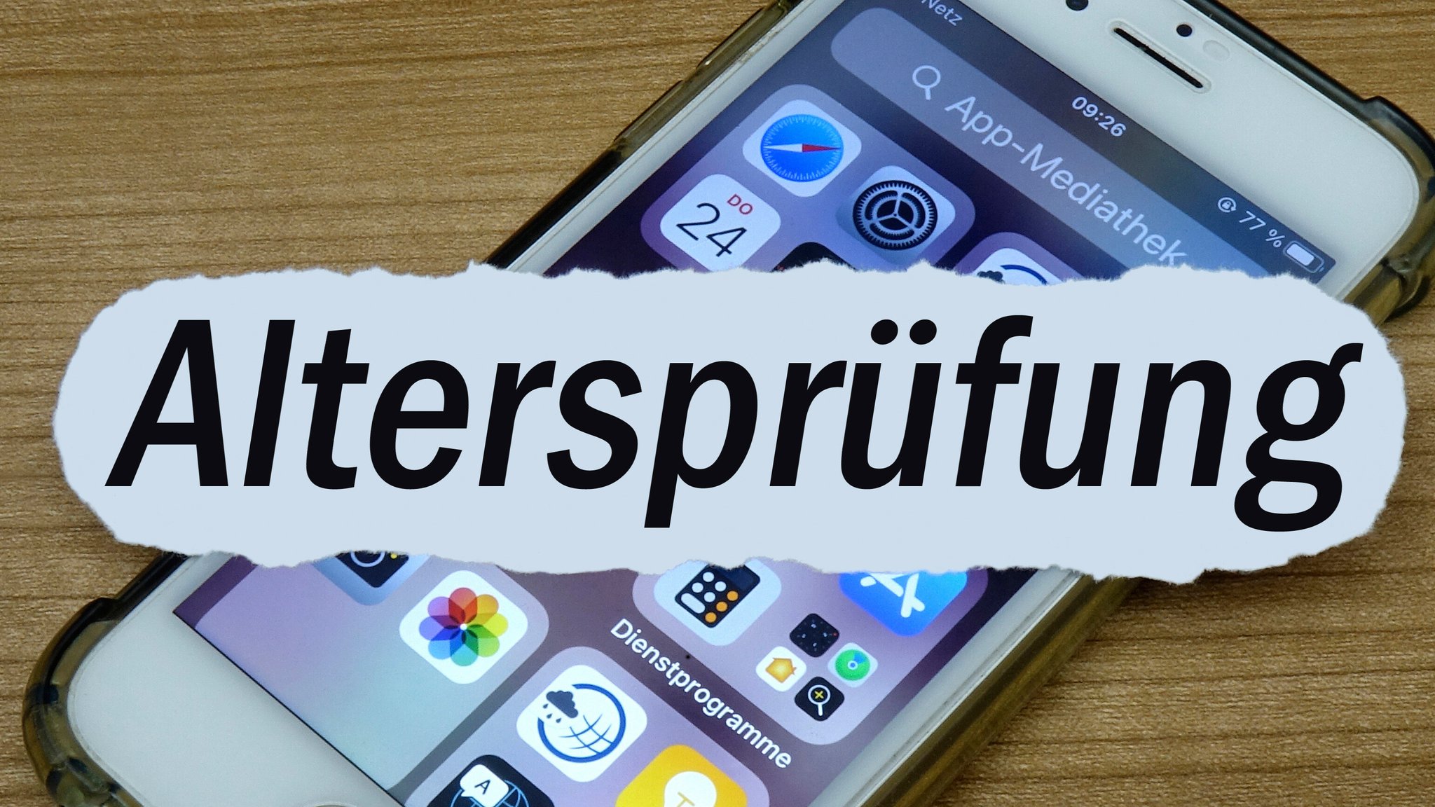 (Symbolbild) Ein Handy liegt auf einem Tisch – quer darüber Schriftzug "Altersprüfung" 
