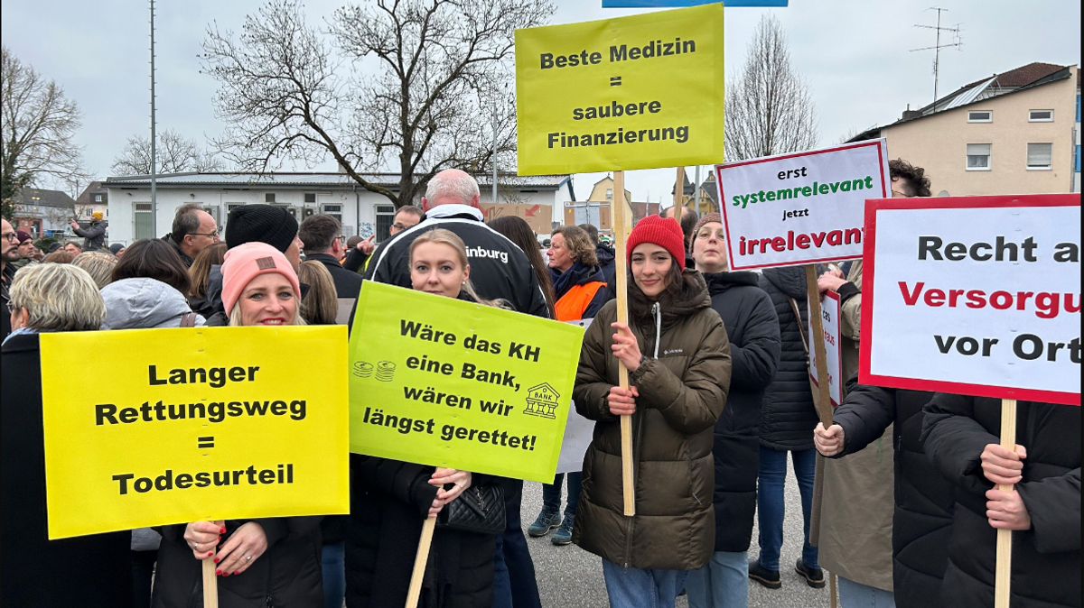 Demonstranten mit Schildern, auf denen der Erhalt des Mainburger Krankenhauses in seiner bestehenden Form gefordert wird.