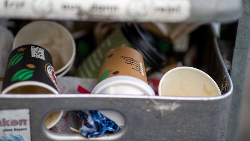 Benutzte Einweg-Kaffeebecher liegen in einem Mülleimer.