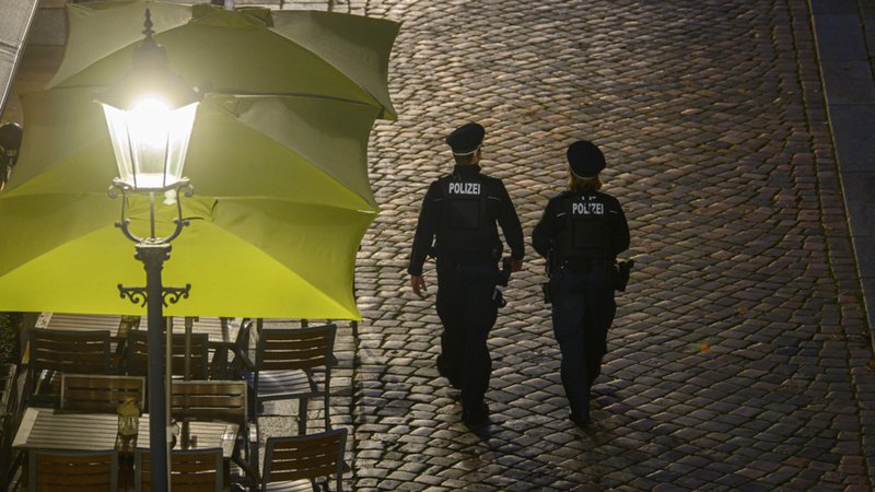 Polizisten gehen am Abend in der Dresdner Altstadt an Restaurants entlang. Die Polizeidirektion Dresden kontrolliert die Einhaltung der neuen Corona-Regeln täglich mit 50 Beamtinnen und Beamten.