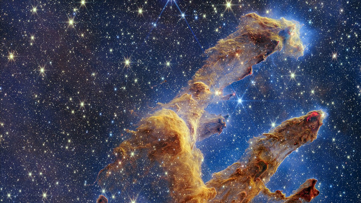 Vor einem Sternenhimmel zeichnen sich bräunlich-gelbliche, wolkenförmige Gebilde ab. Sie scheinen wie Finger von unten nach oben zu deuten. 