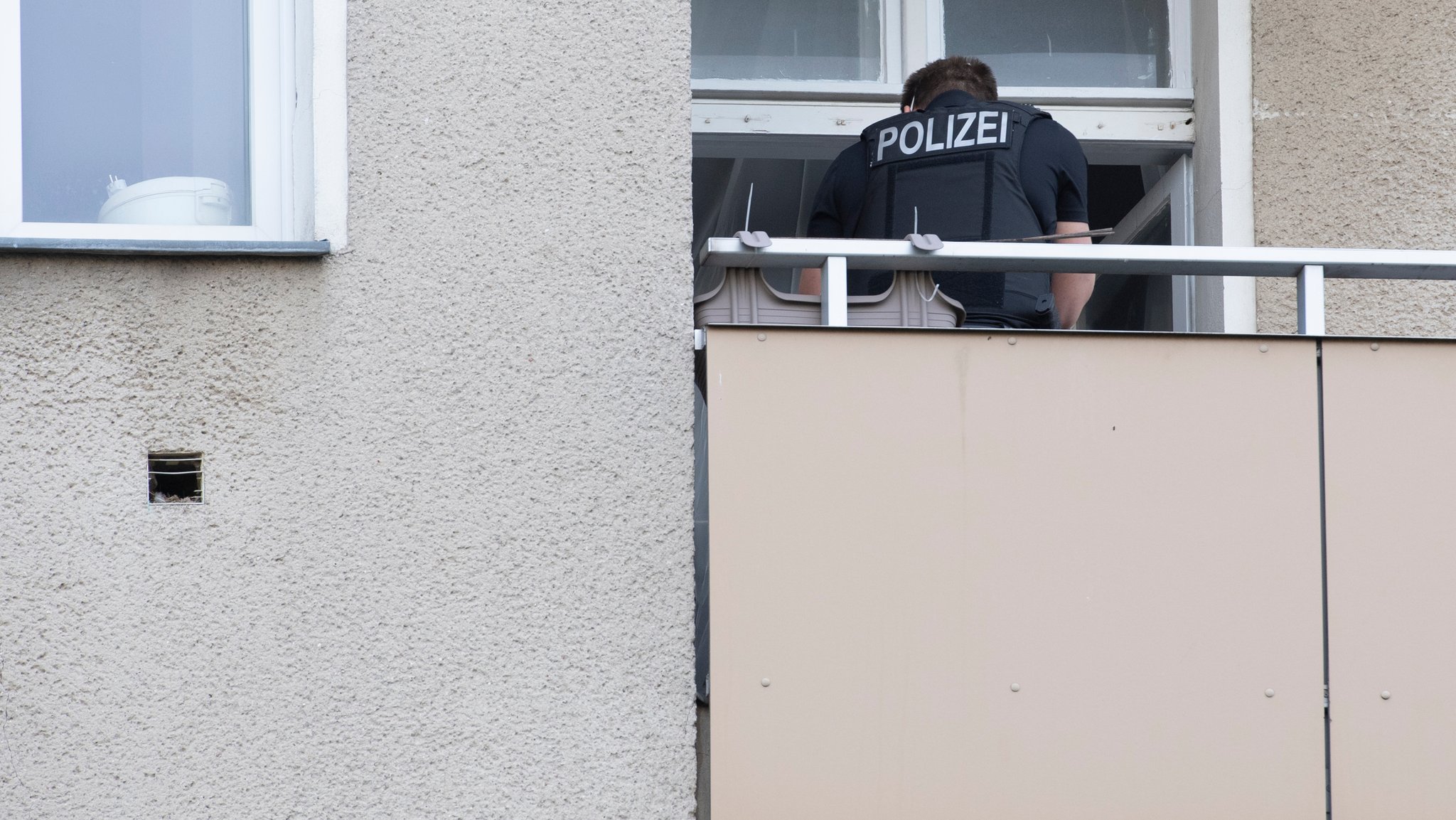 Ein Polizist durchsucht eine Wohnung