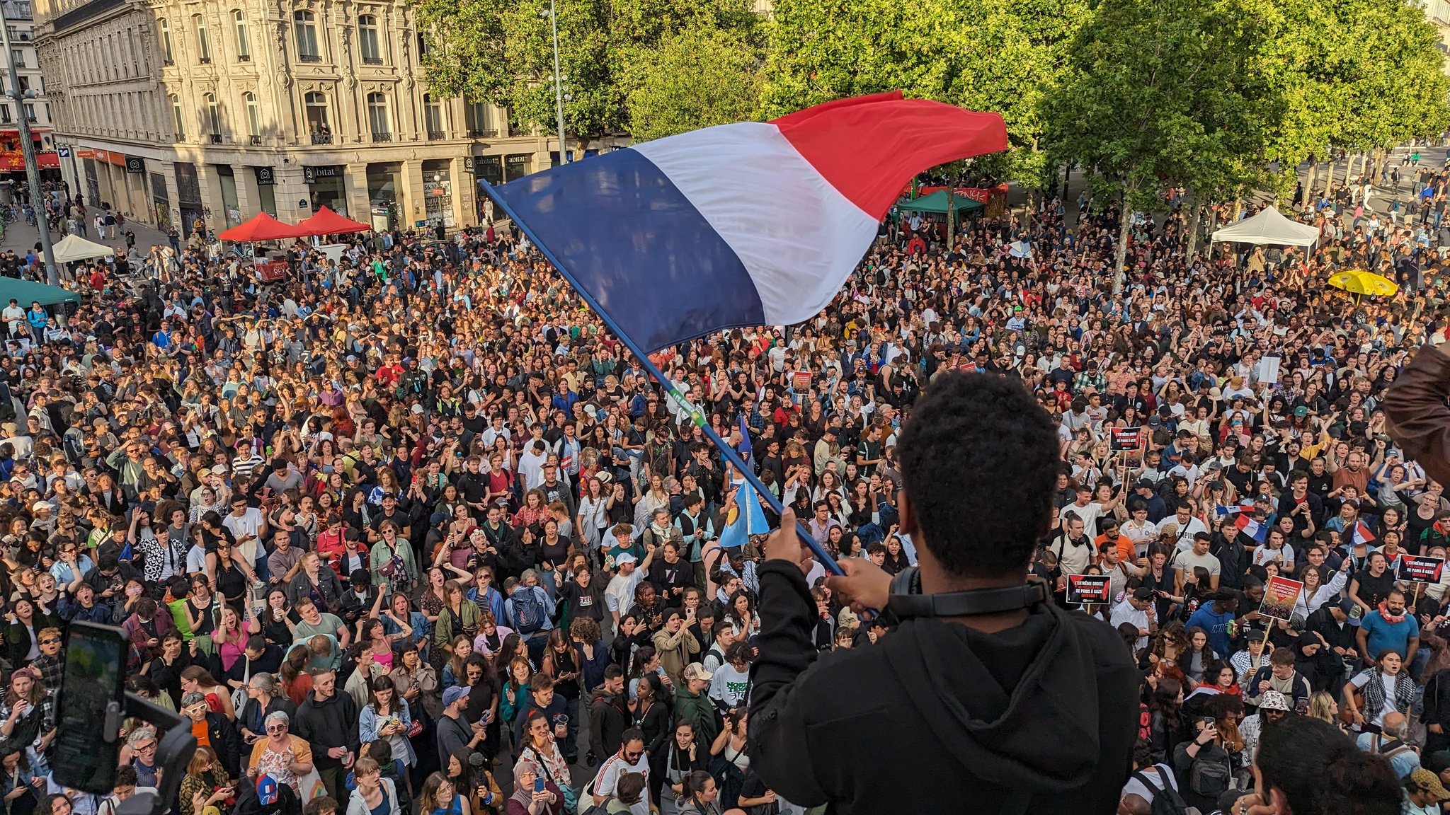 Menschen in Paris haben sich am Wahlabend auf einem Platz versammelt