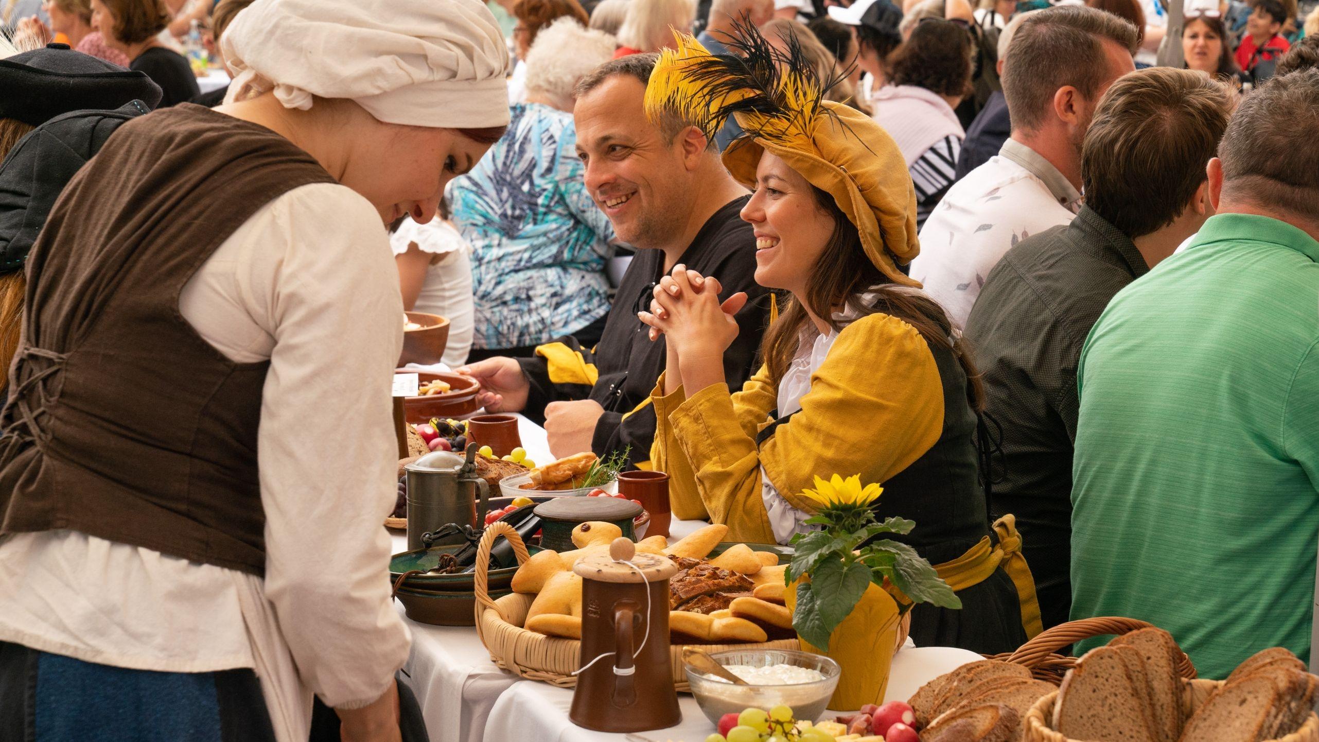 Teilnehmer sitzen an der Friedenstafel in Augsburg