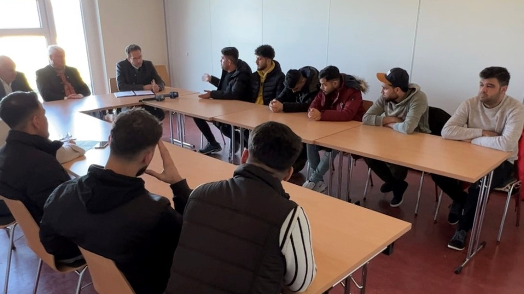 Runder Tisch im Feuerwehrhaus: Bürgermeister, Landrat und Flüchtlinge beraten gemeinsam, wie es weitergehen soll.
