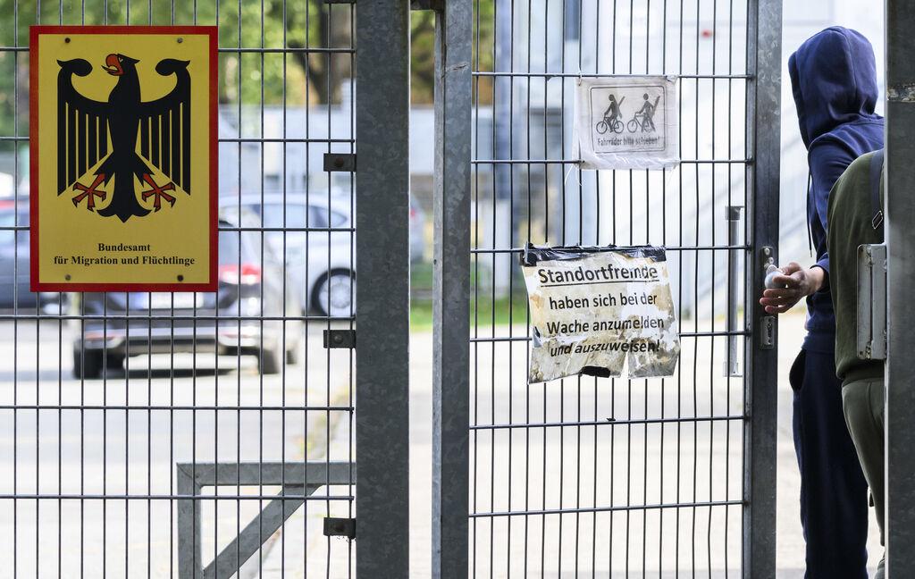 ARCHIV - 18.10.2023, Niedersachsen, Braunschweig: Ein Mann betritt neben einem Schild vom Bundesamt für Migration und Flüchtlinge die Landesaufnahmebehörde Niedersachsen am Standort Braunschweig. (zu dpa: «Flüchtlingszahlen zu Jahresbeginn gesunken») Foto: Julian Stratenschulte/dpa +++ dpa-Bildfunk +++