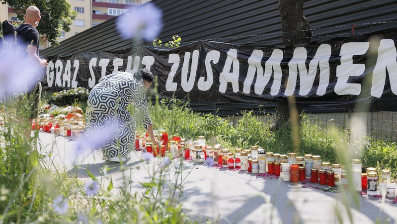 Beileidsbekundungen liegen vor der Schule nach dem Amoklauf in Graz mit zehn Todesopfern. | Bild: dpa-Bildfunk/Erwin Scheriau Beileidsbekundungen liegen vor der Schule nach dem Amoklauf in Graz mit zehn Todesopfern.