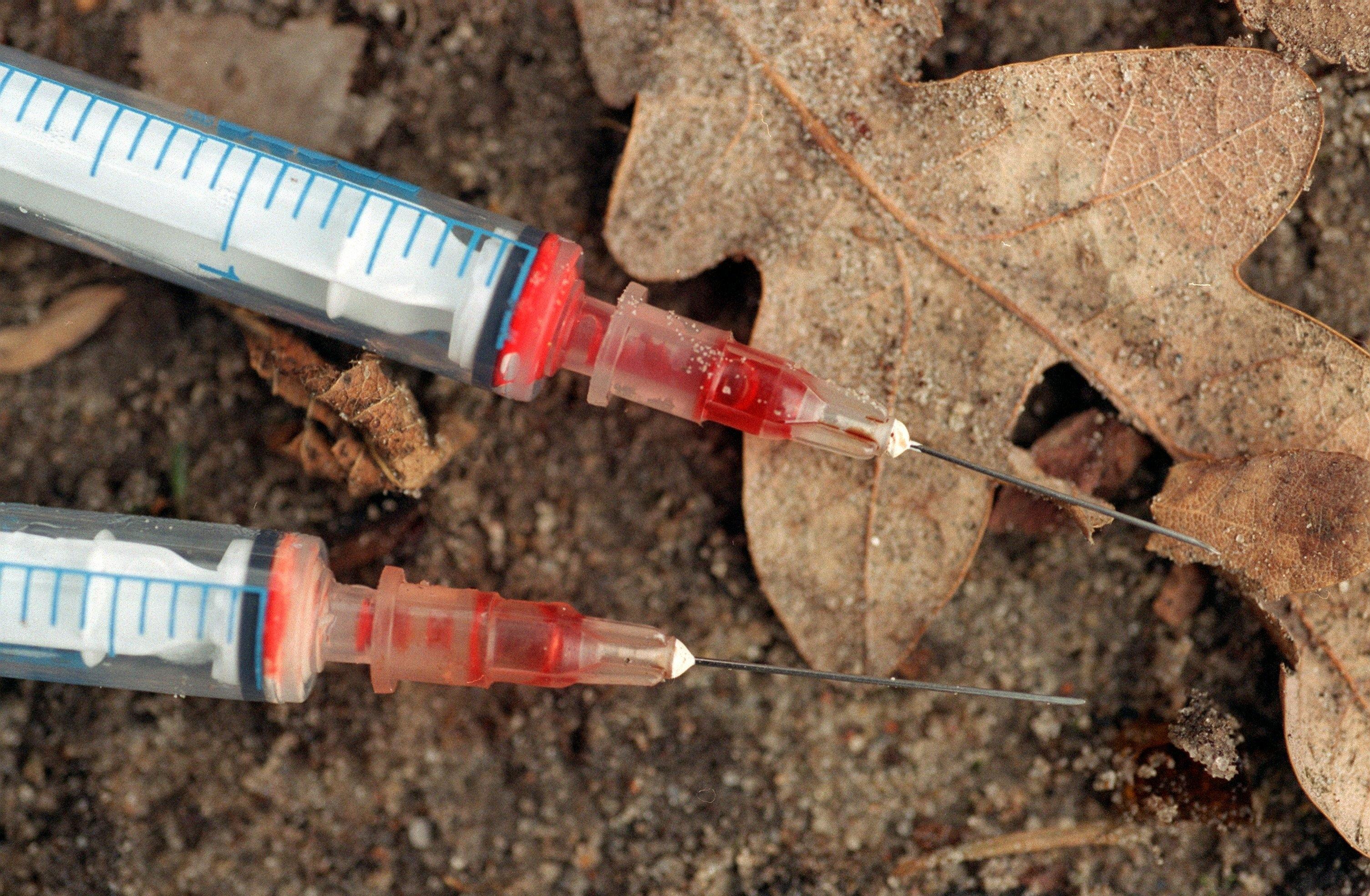 Symbolbild: Blutverschmierte Spritzen liegen auf dem Boden 