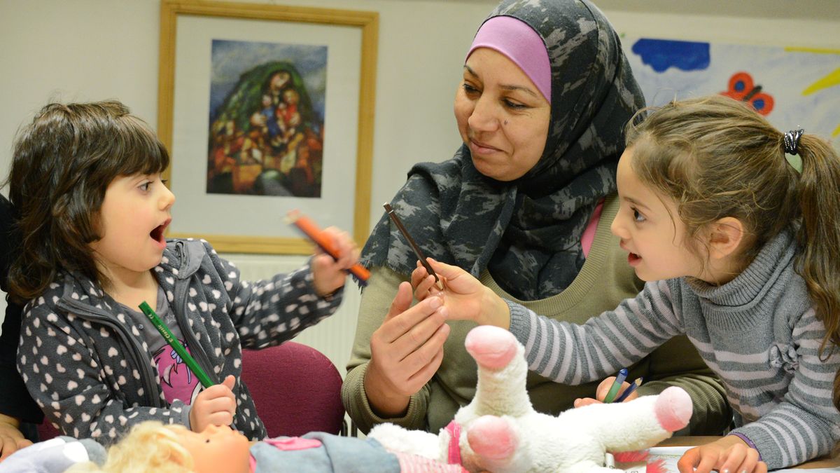Eine Frau mit Kopftuch unterrichtet Kinder (Symbolbild)