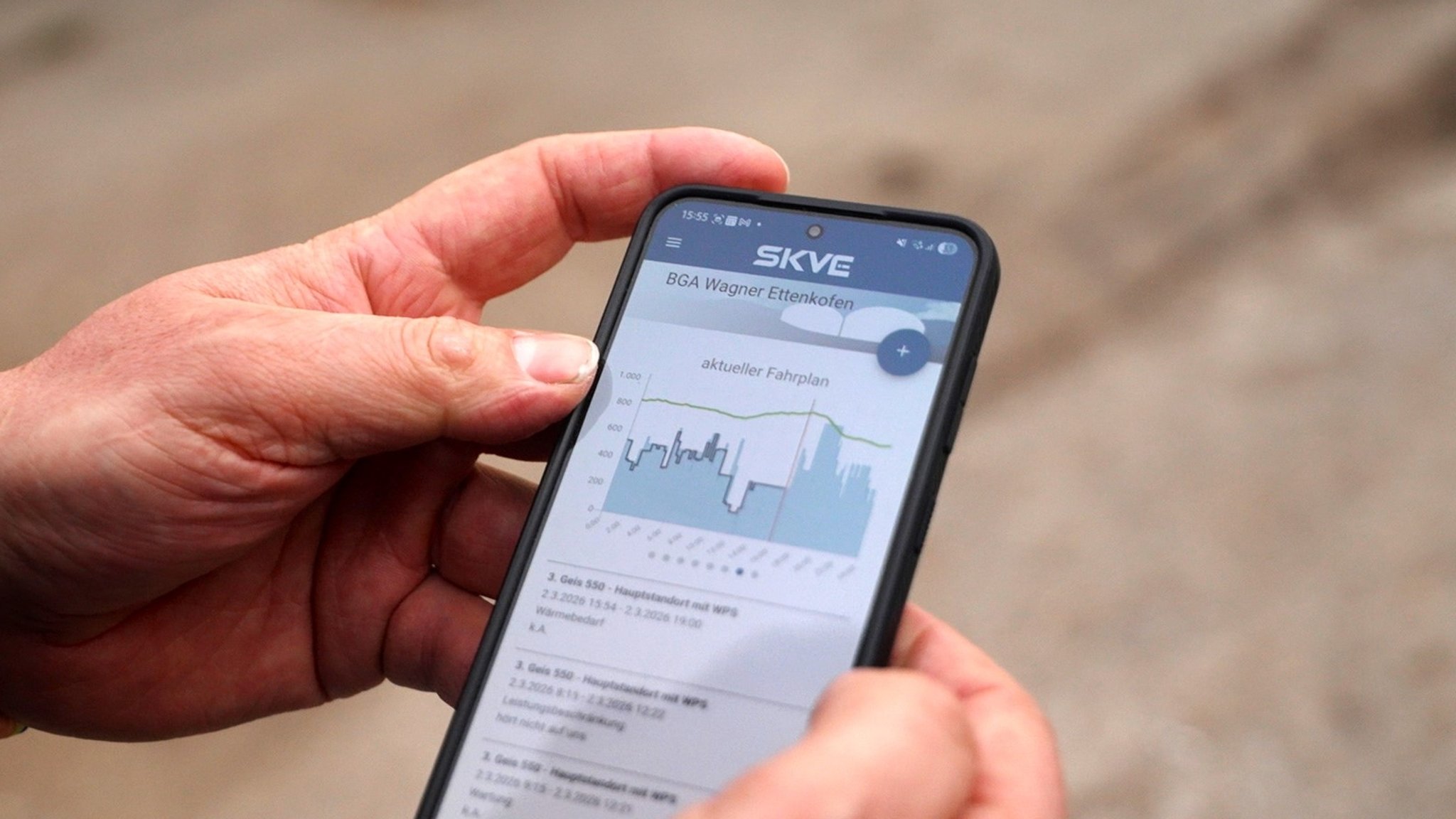 Landwirt Wagner sieht sich am Handy die App von SKVE an.
